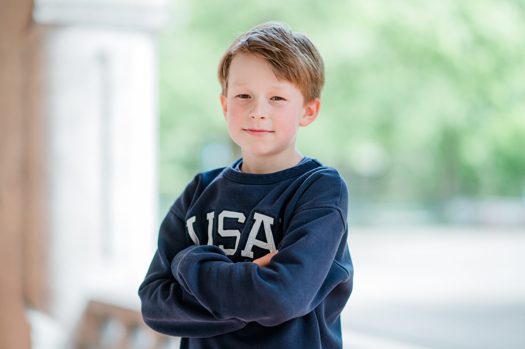 A boy with folded arms during a nursery photography session